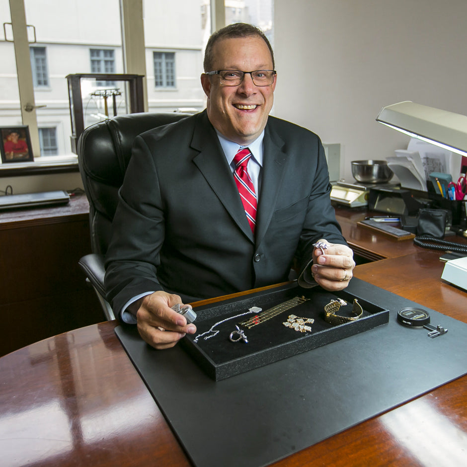 Photo of Andrew Fabrikant evaluating jewelry